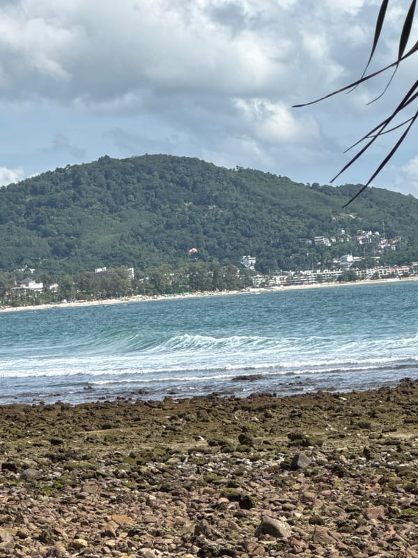 Morning at Patong's rocky coastline and beach