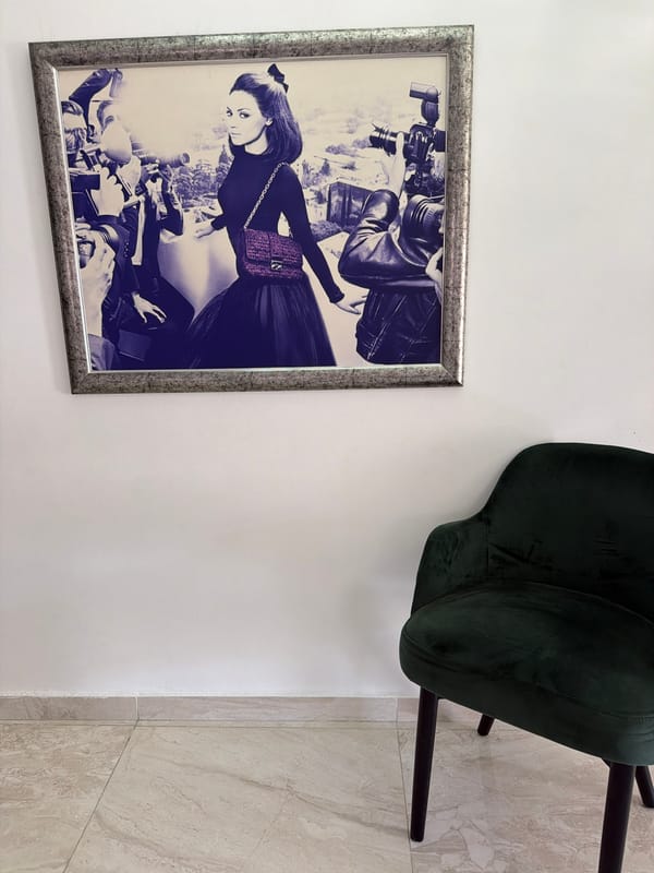 Framed portrait photographed beside green chair in Malta home