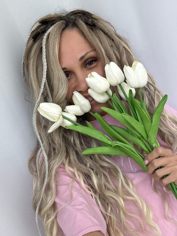 Woman poses with flowers and accessories in Rusanovo photoshoot