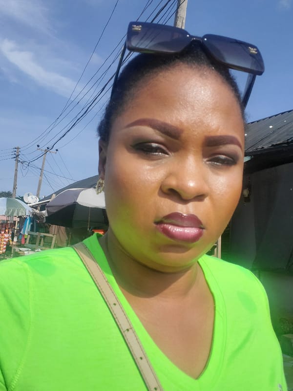 Woman takes selfies in bright sunlight in Lagos