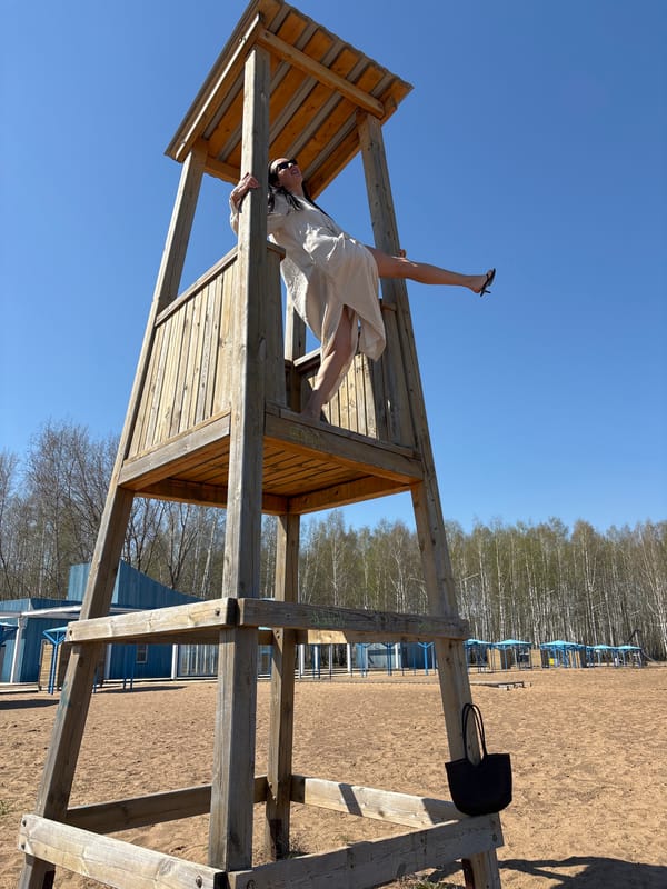 Woman performs acrobatics on playground equipment in Chaikovsky