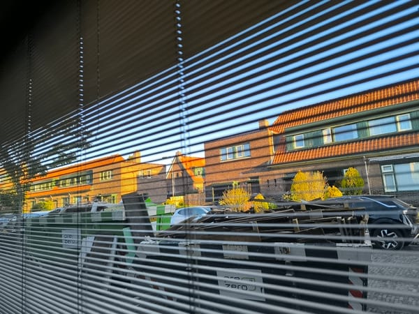 Morning street view captured through venetian blinds in Arnhem