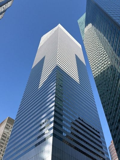 NYC skyscrapers photographed from low angle against clear sky