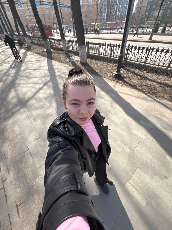 Person takes selfie on sidewalk in Perm, Russia