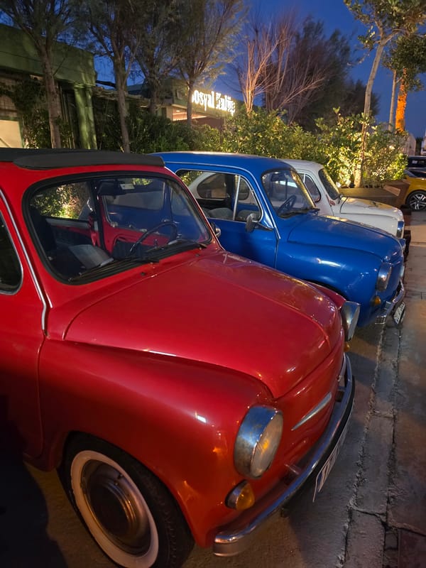 Güzelbahçe waterfront at golden hour, vintage cars and seaside strollers