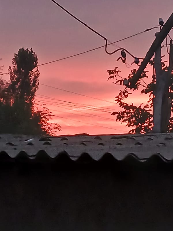 Vivid pink and orange sunset over rural Sadovoe, Kyrgyzstan