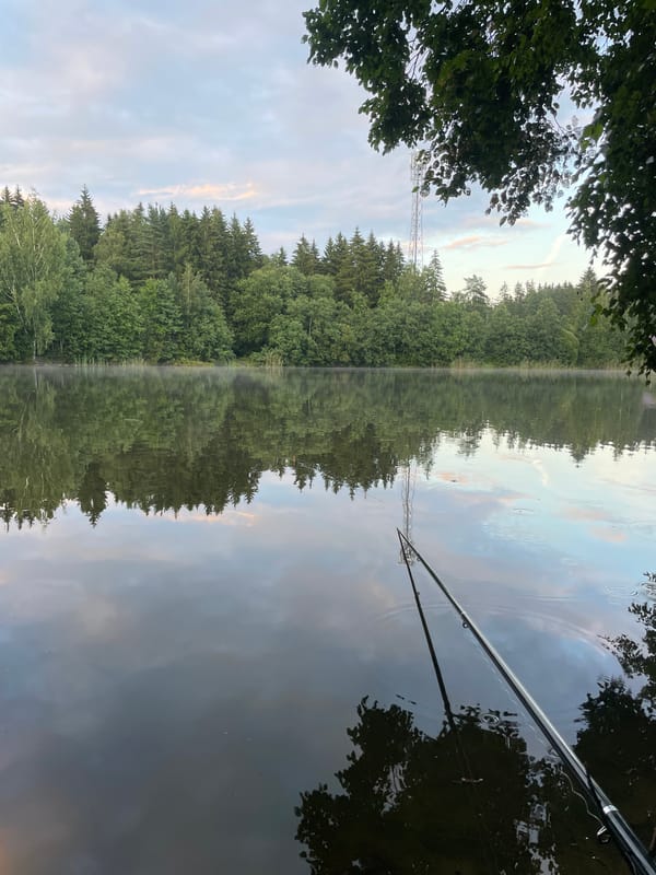 Evening fishing on a misty Russian lake at dusk