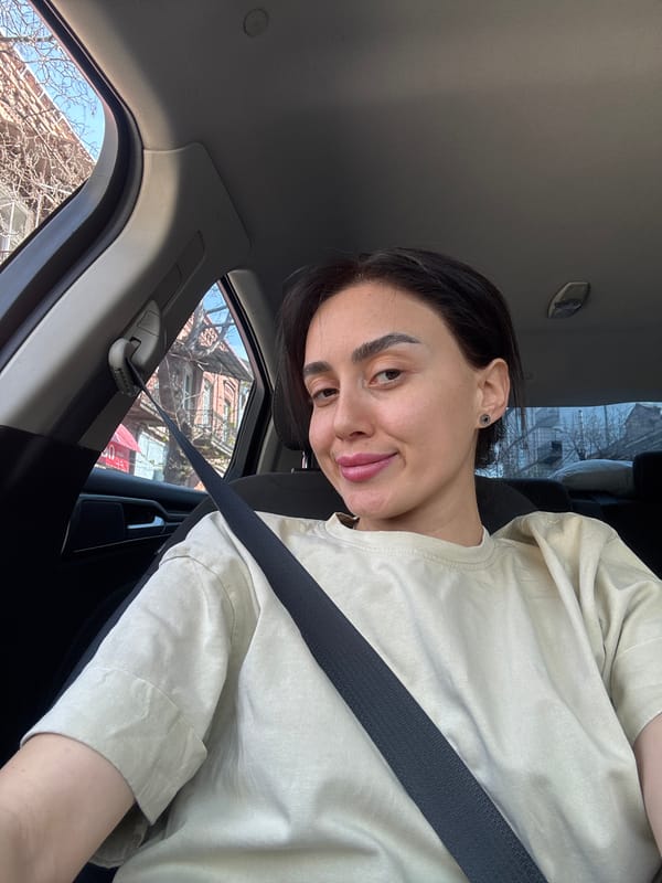 Woman photographed during car journey through Tbilisi streets