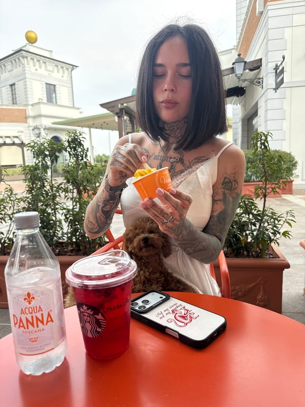 Woman enjoys afternoon chocolate break with poodle in Italian café