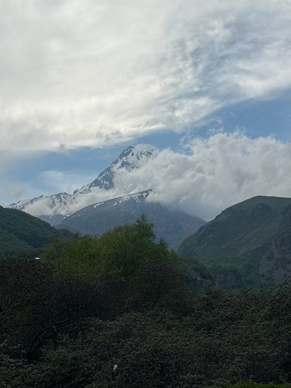 Tourist documents scenic mountain views in Stepantsminda, Georgia