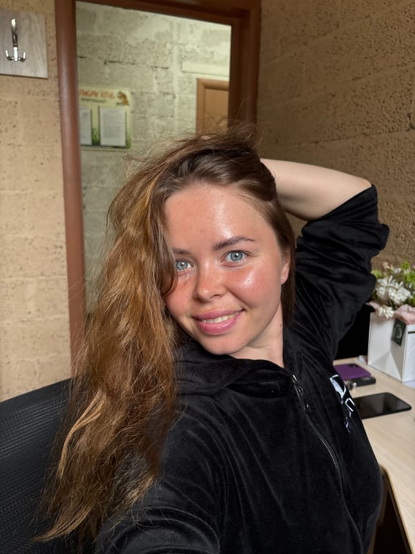 Woman takes multiple selfies in black tracksuit, Russia morning