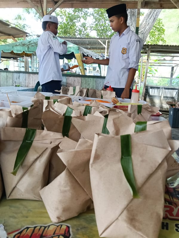 Students distribute food near mosque in Lhokseumawe, Indonesia