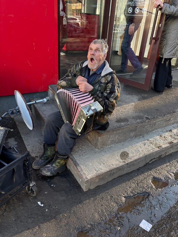 Street musician and child at play captured in Izhevsk