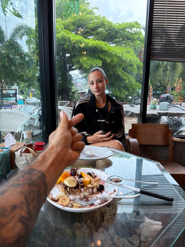 Woman dines at restaurant window in Chalong, Thailand