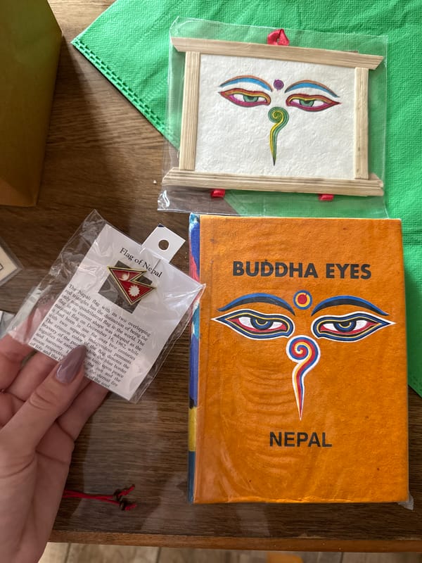 Tourist examines Buddha Eyes souvenirs in Pokhara, Nepal