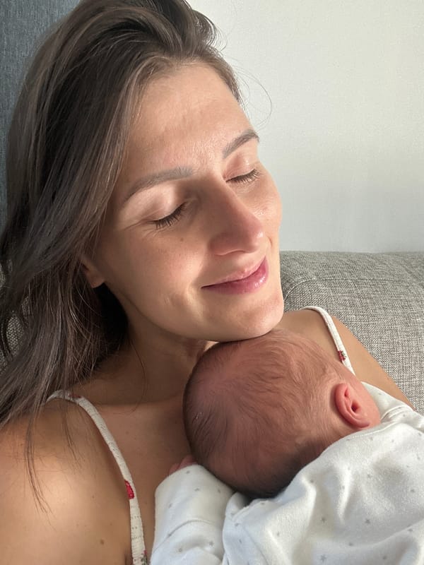 Mother holds newborn baby in intimate moment in Wisła