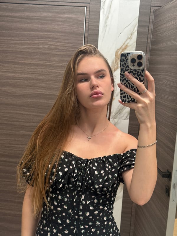 Mirror selfie series in a Dnipro bathroom, floral black dress