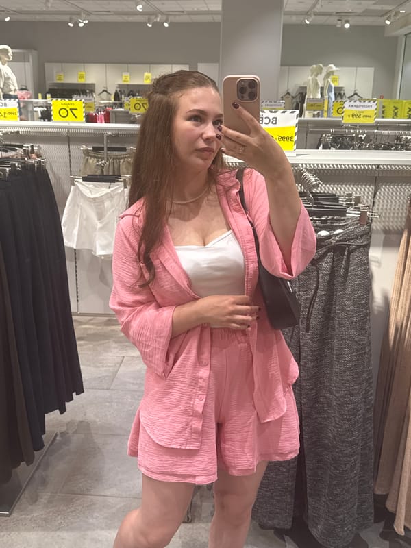 Trying on a pink two-piece set in an Izhevsk clothing store