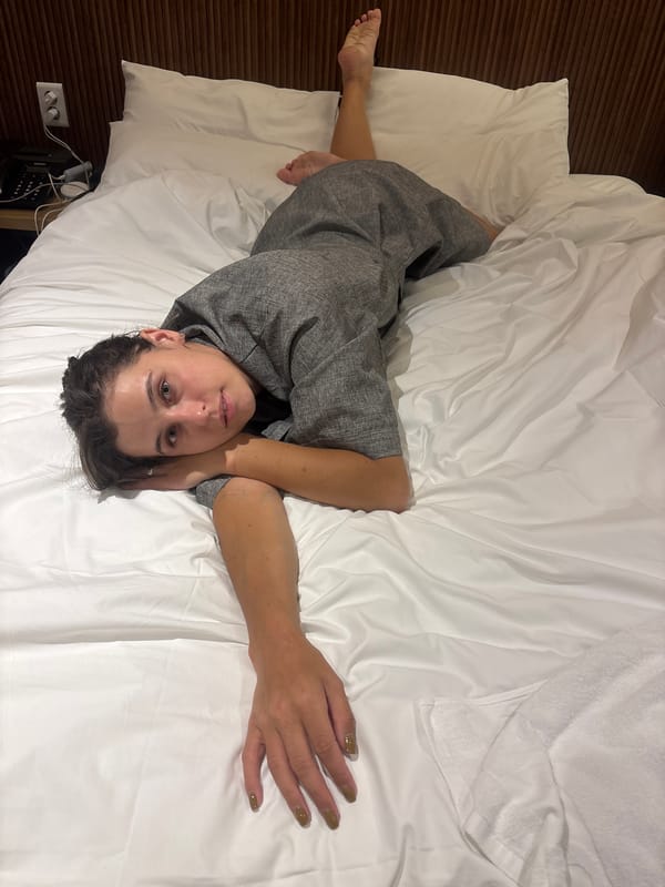 Relaxing on a white bed in a grey robe, Incheon