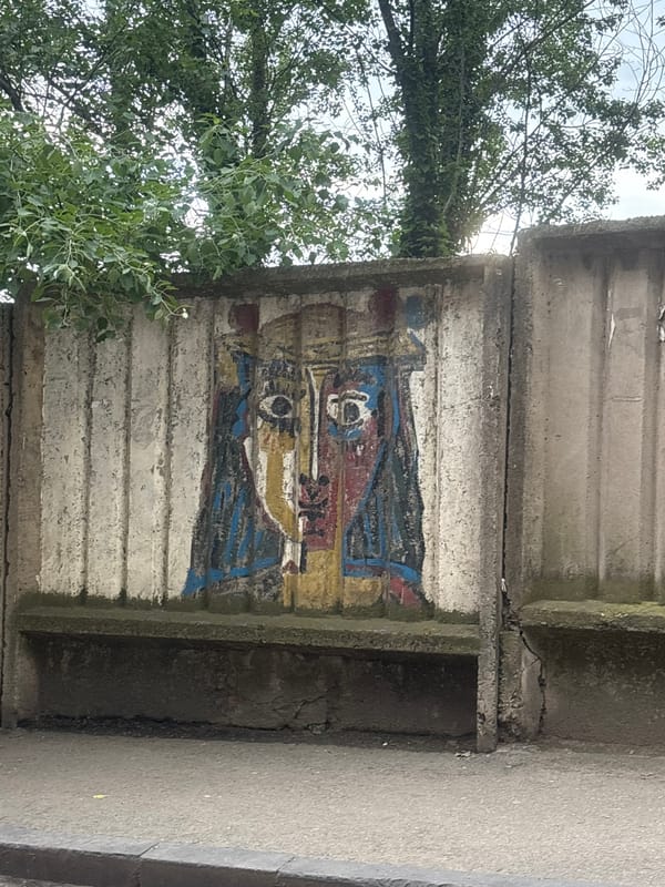 Street scenes captured in Tbilisi featuring murals and taxi