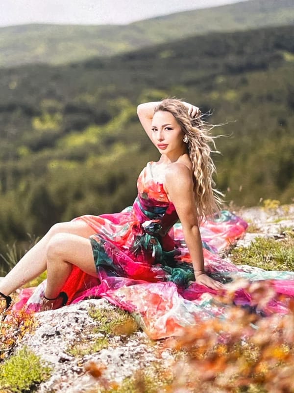 Woman poses for photos on rocky outcrop