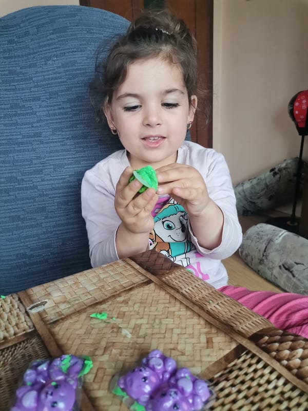 Children craft with clay and playdough at tables