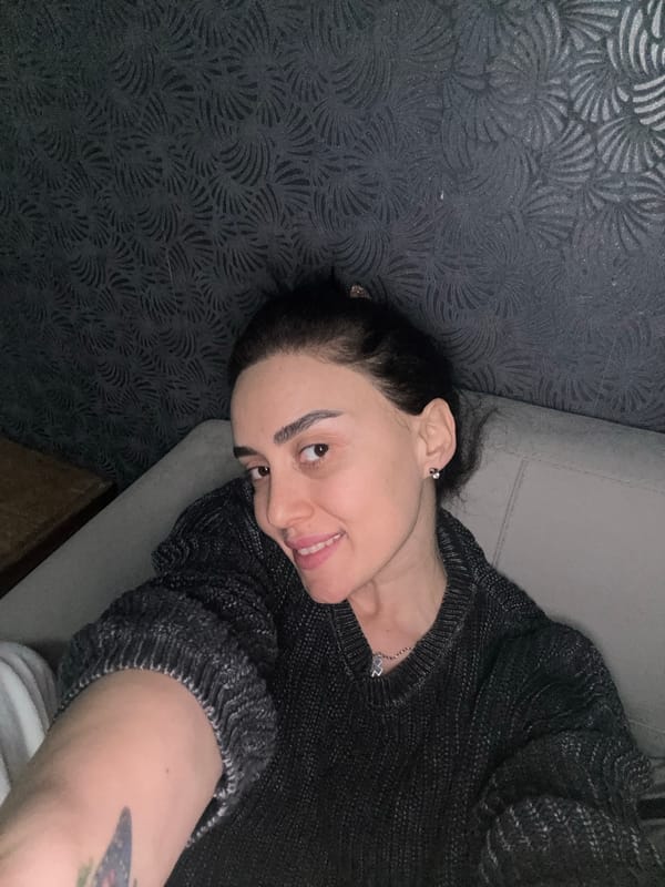 Woman poses peacefully on couch in Tbilisi home