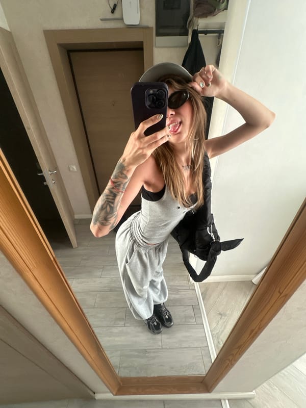 Mirror selfies in grey outfit at Moscow apartment
