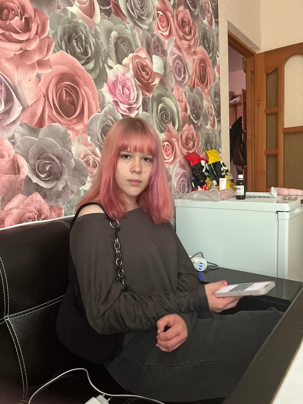 Pink-haired youth rests on sofa in Semyonov home