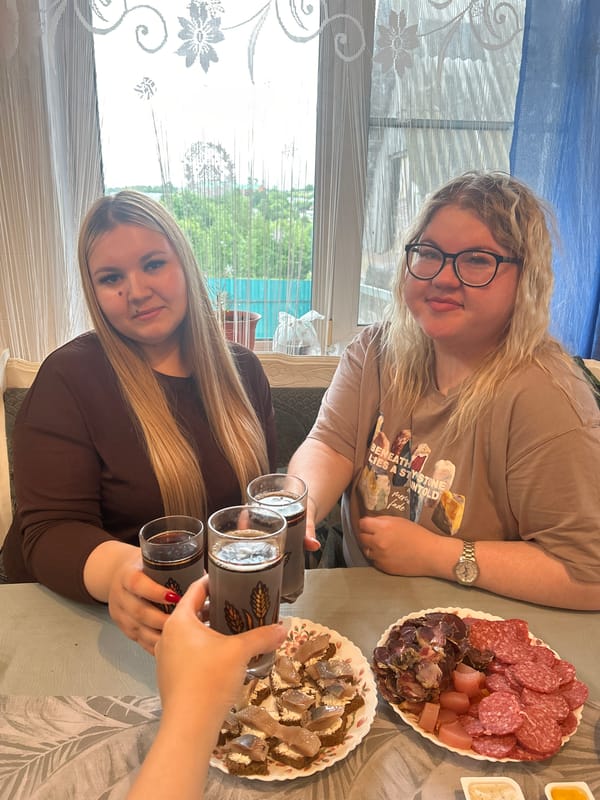 Women share meal with spread of food in Фоки