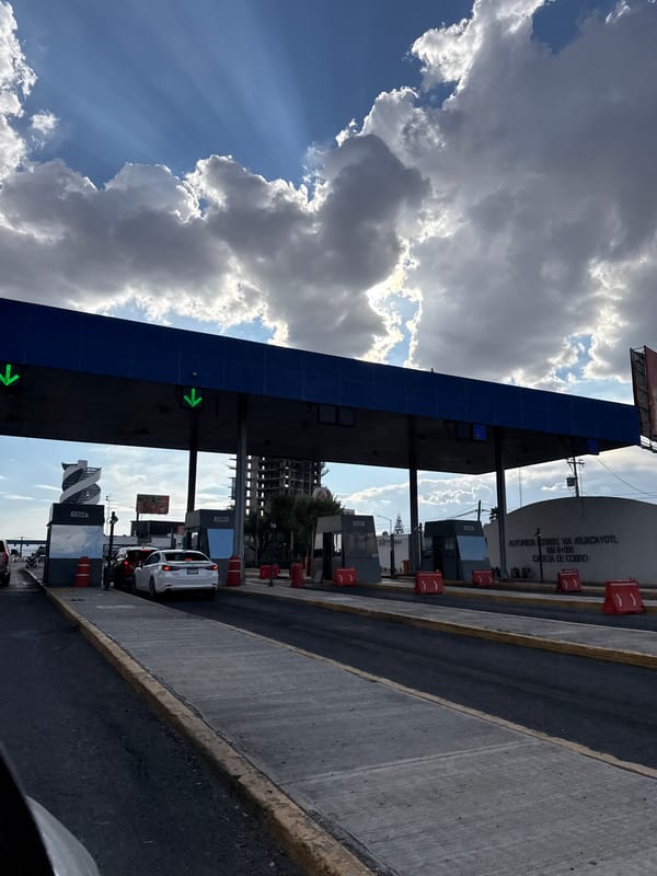 Toll booth documented on Mexican highway under partly cloudy skies