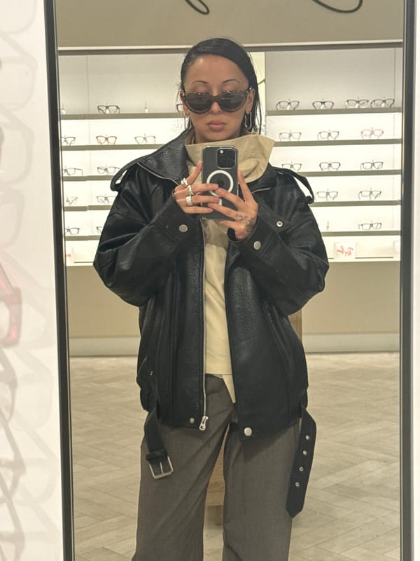 Person takes mirror selfie in London eyewear store