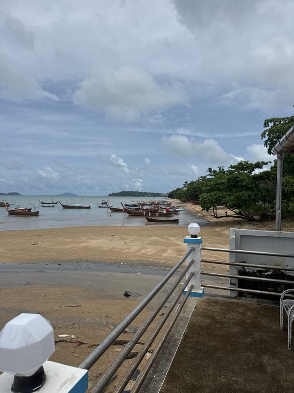 Morning scenes from Rawai beach show boats, beachgoers, overcast skies