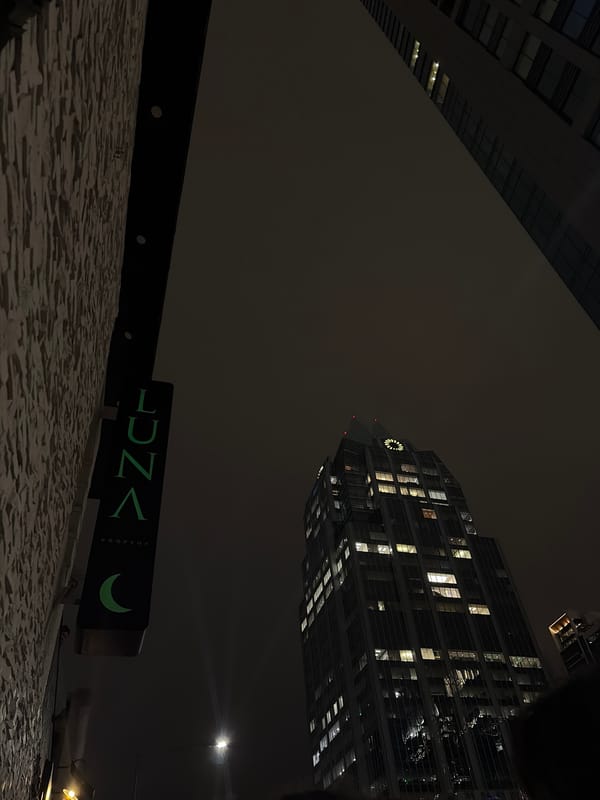 Green rooftop signage photographed at night in Austin