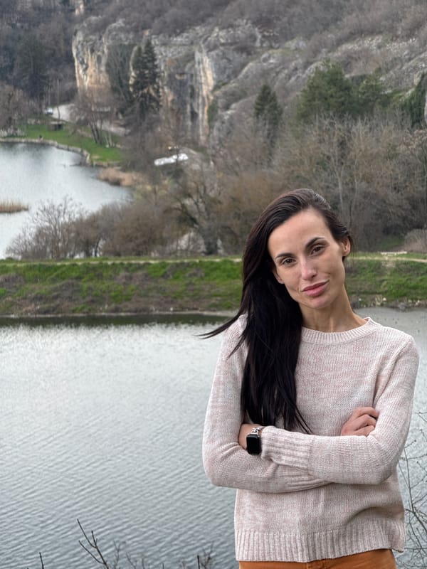 Woman photographs spring blossoms, scenic views at Bulgarian park
