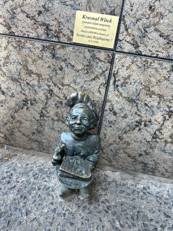 Tourists photograph iconic bronze dwarfs in Wrocław historic district