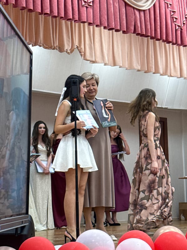 Indoor graduation ceremony unfolds on decorated stage in Moscow