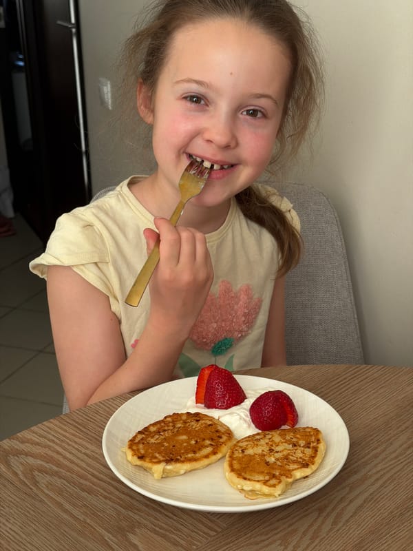 Young girl enjoys pancake meal in Riga
