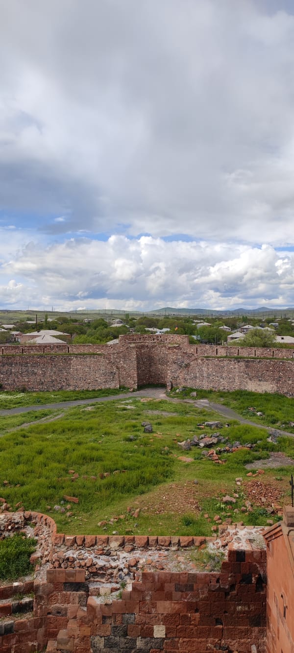 Tourist documents medieval Dashtadem Fortress during Armenian countryside visit