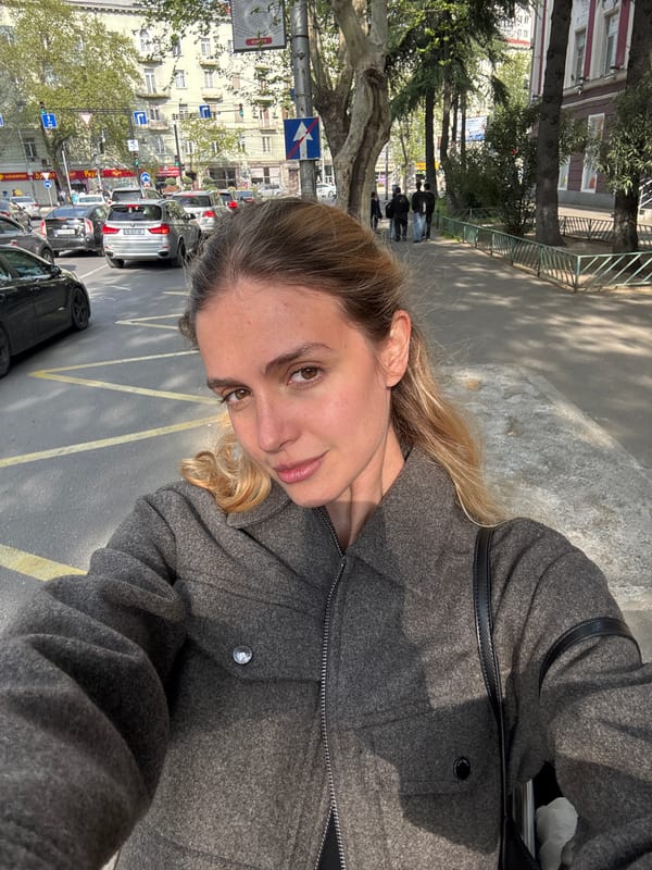 Woman takes selfie on busy urban street