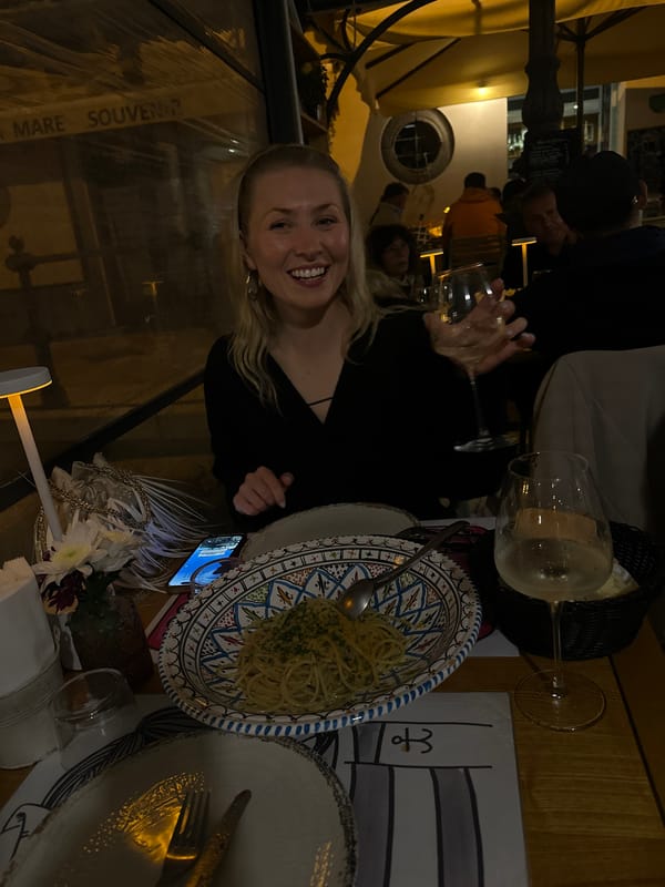 Woman enjoys evening dinner at Lipari restaurant