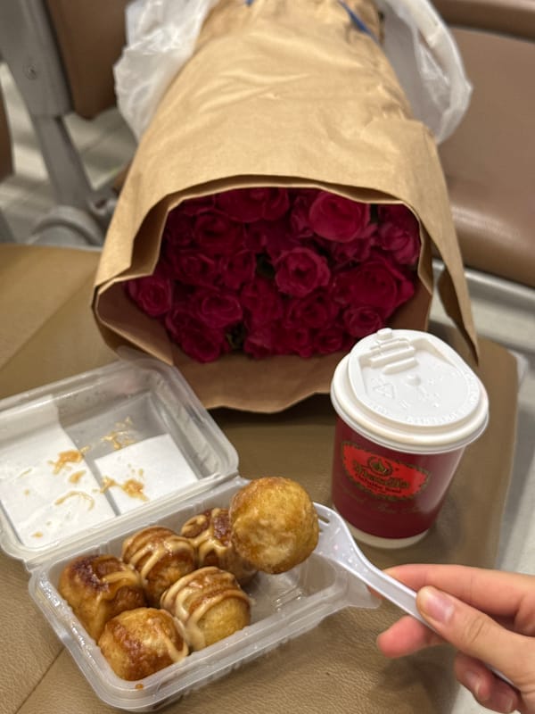 Roses on a cafe table, toddler on the tiles nearby
