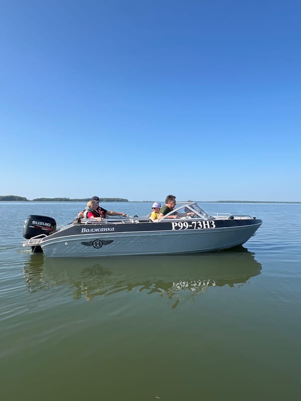 Fishing trip on a calm Russian lake aboard the Волжанка
