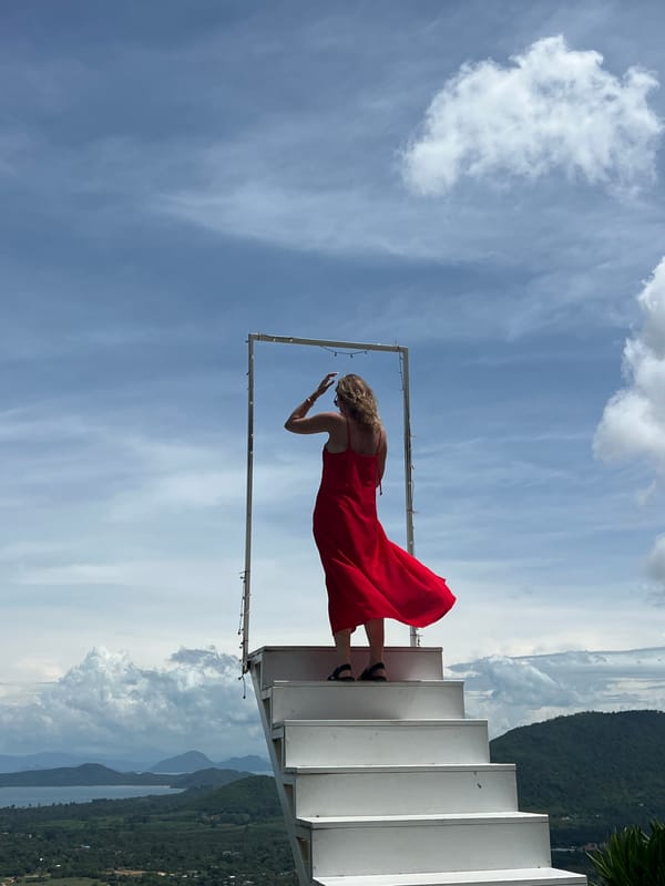 Visitors pose at hillside staircase art installation in Thailand