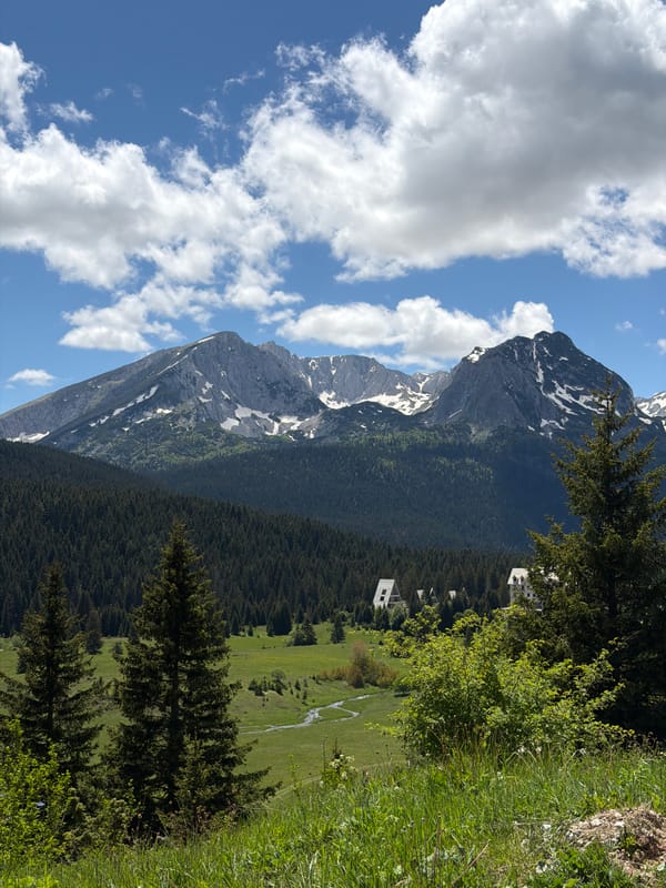 Tourist plays with shadows amid Montenegro's mountain scenery