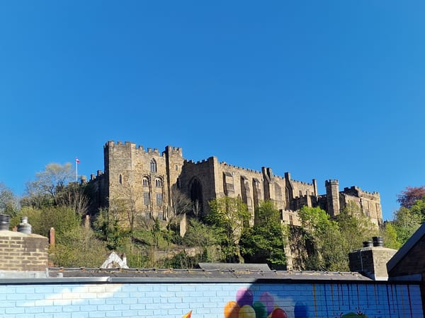 Durham Castle observed under clear skies with red flag