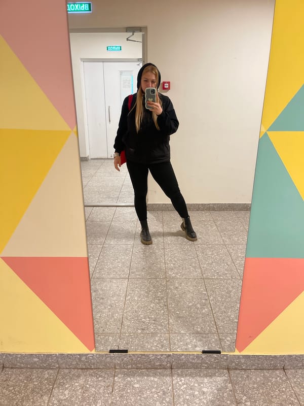 Person reflected in mirror inside decorated building in Izhevsk