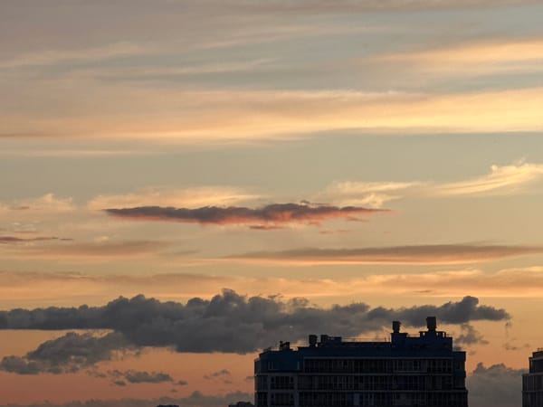 Layered sunset sky over a Russian city skyline