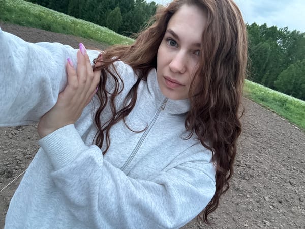 Woman rests in blooming wildflower field in rural Russia