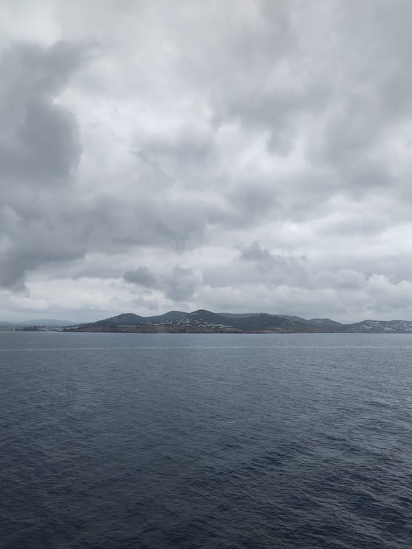 Pilot boat navigates choppy waters around Ibiza under overcast skies